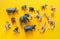 African animals in plastic. The figure of a mammal is tangled in the package. Yellow background