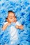 African baby laying and sleeping on the blue cloth