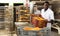 African baker carrying box with baked bread