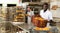 African baker carrying bread in box