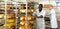 African baker carrying fresh bread on trolley