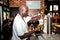 African Barman pouring a pint draft beer at barman training school