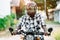 African biker in the helmet and glasses driving a motorcycle rides