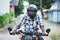African biker in the helmet and glasses driving a motorcycle rides