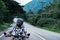 African biker man in the helmet riding a motorcycle rides on highway road