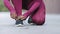 African black female hands tying shoelace on running shoes before practice. Woman athlete preparing for jogging outdoors