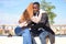 African black man and redhead caucasian woman hugging with a rose