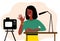 African black Woman blogger make video tutorial. Female podcaster talking to camera using microphone. Vector illustration in flat