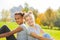 African and blond girl sitting together in park