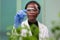 African botanist woman looking at genetic test sample for biological experiment