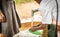 African boy cleans his plastic dish at the local town water pump.