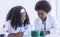 African boy and girl studying science at school