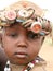 African boy wearing bottle caps