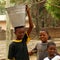 African boys taking water - Ghana