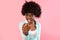 African Bushy Woman Pointing Finger At Camera Over Pink Background