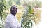 African business man in white shirt looking and thinking in green nature