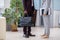 African businessman with handbag and Caucasian businesswoman with documents