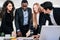 African businessman planning and discuss with Caucasian colleagues that looking on documents at an internal business group meeting