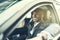 African businessman smiling while driving his car in the city