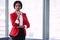 African businesswoman looking into camera confidently while wearing red blazer