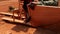 African carpenter cuts a plank of wood with the hand saw, work in the workshop