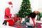 African child sister and Santa Claus celebrate winter holiday together, Santa play ukulele and sing a song, two cute girl kid