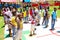 African children lining up to take turns to take a goal shot on public playground basketball court