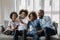 African couple with little kids making selfie seated on couch