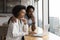 African couple spend time together in domestic kitchen with laptop