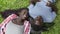 African couple of teenagers seated on a park working with tablet. Slow motion