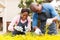 African couple trimming plants