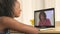African couple video chatting on laptop