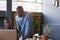 African coworkers using a laptop together in a modern office