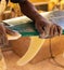 An African Craftsman surfboard Shaper working in a repair workshop