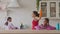 African daughters helping mother cleaning kitchen