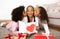 African Daughters Kissing And Surprising Mother With Gifts At Home