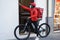 African delivery man with electric bike ringing the doorbell - Focus on face