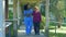 African Doctor helps elderly woman to walk in a hospital rehab garden