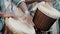 African drummers in ethnic clothes playing on djembe drum close up. Musician beats rhythm on african drums. Black