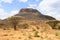 African dry hot savanna with dried plants and mountains