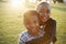 African elementary school boy and girl hugging outdoors