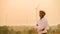 African engineer windmills wearing white hard hat and using tablet with   wind turbine on silhouette sunset