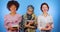 African, European and Muslim students with books to study isolated on a blue background. International, cute, education