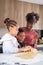 African family kneading cookie dough in the kitchen.