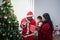 African family, Nigerian father wearing a red Santa costume open gift box for a 4-month-old son