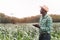 African Farmer stand in the green farm with holding tablet