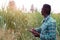 African Farmer  stand in the green farm with holding tablet