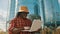 African farmer using laptop in front of the silo storage system