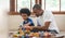 African Father and boy playing colourful wood blocks toy