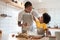 African Father and son enjoying during bake cookies at home together